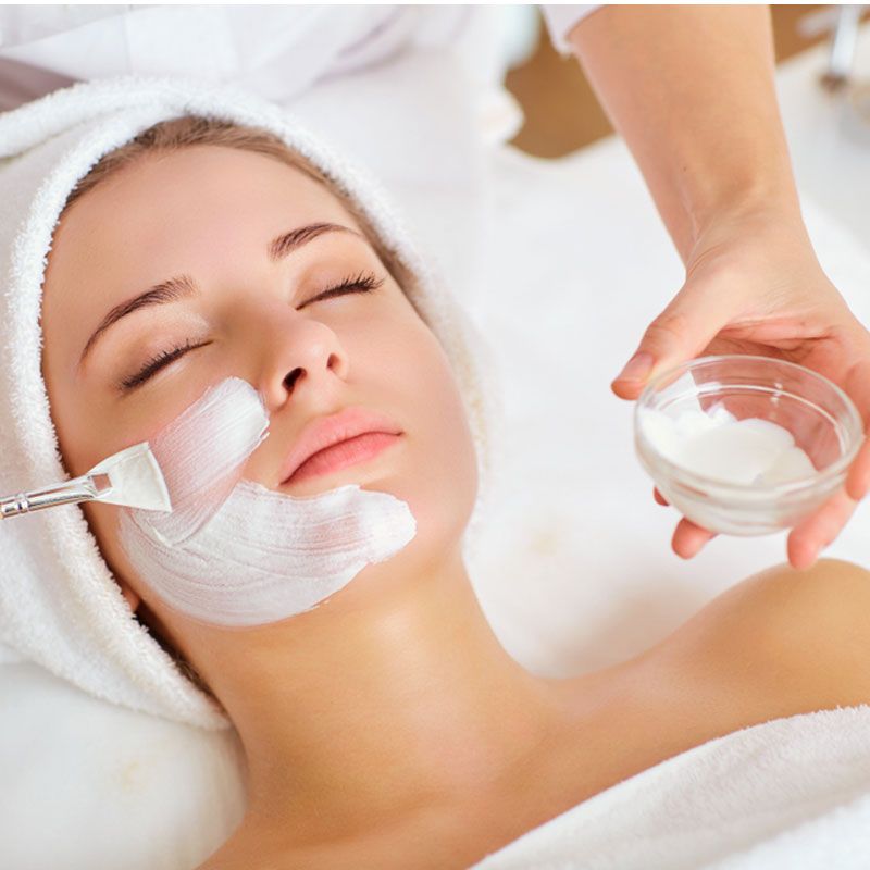 A facial treatment being applied with a brush