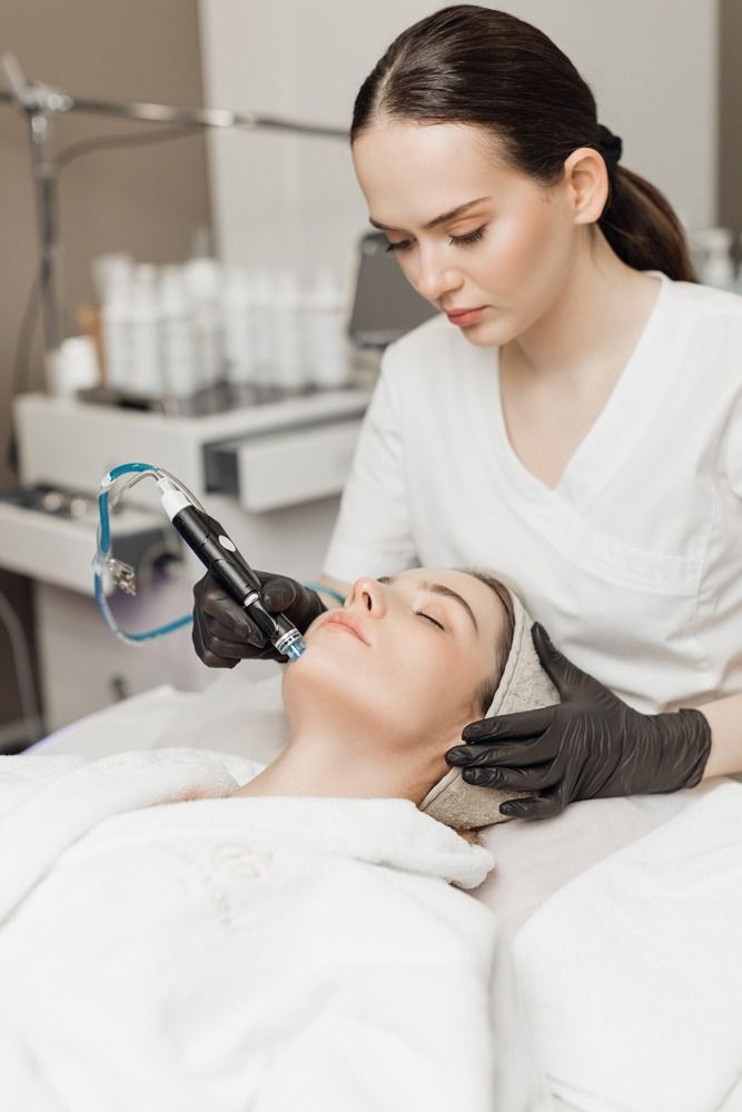A skin treatment being performed with a handheld device